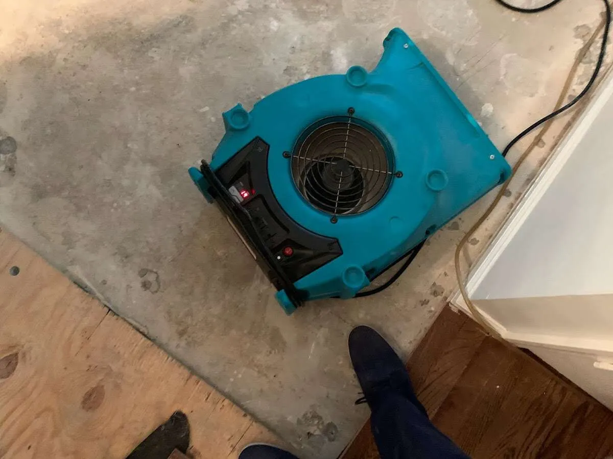 Air mover drying subfloor during Commercial Water Damage Restoration in Galion